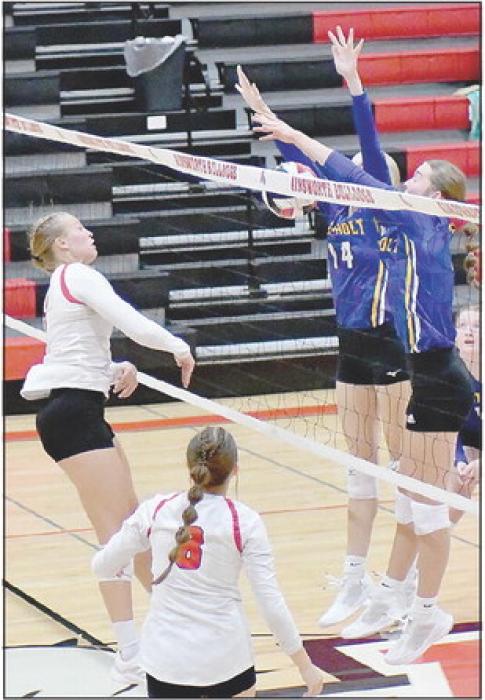 Kendyl Delimont gets a kill shot past the blockers on the West Holt Volleyball Team.