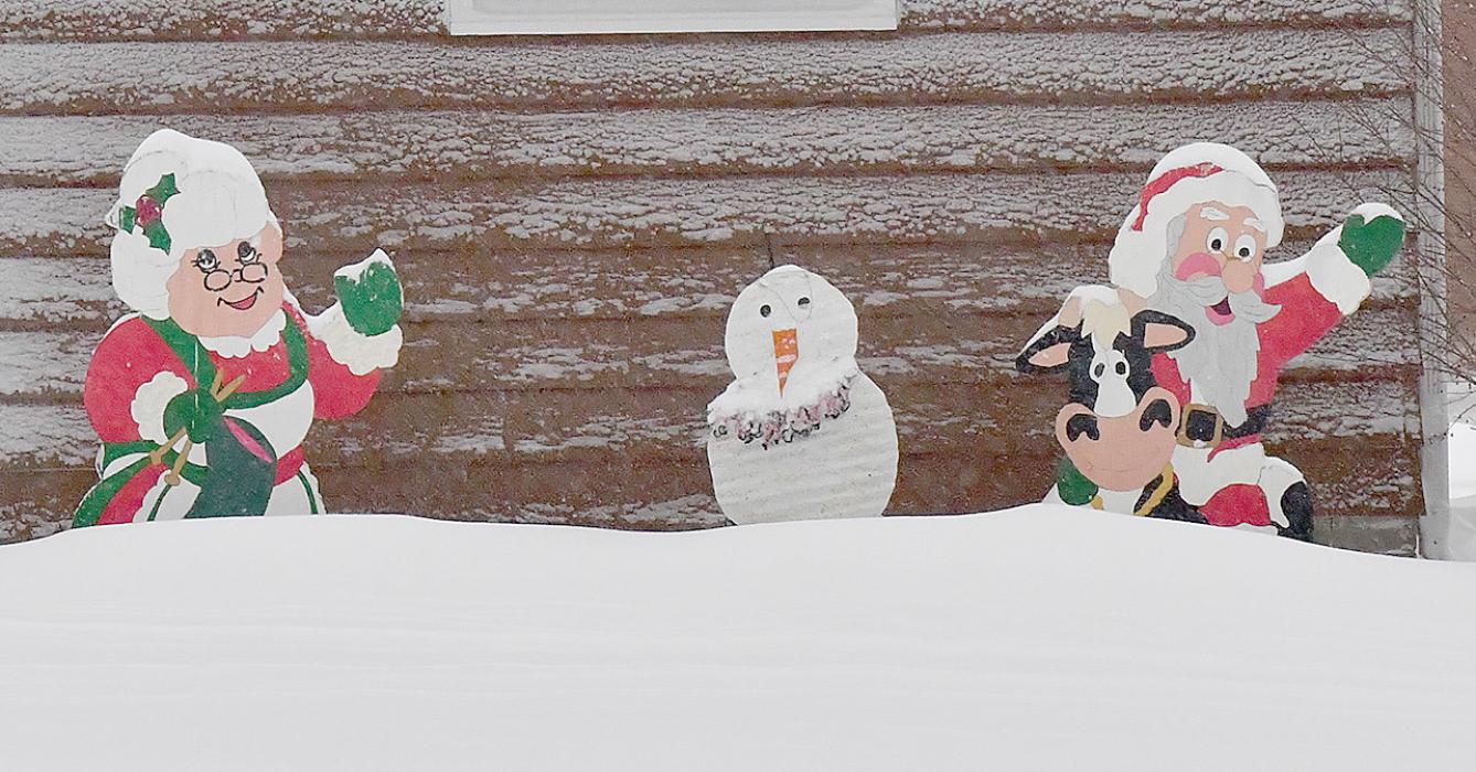 Santa and Mrs. Claus seemed to enjoy the snow and looked very happy with a snow drift in front of them.