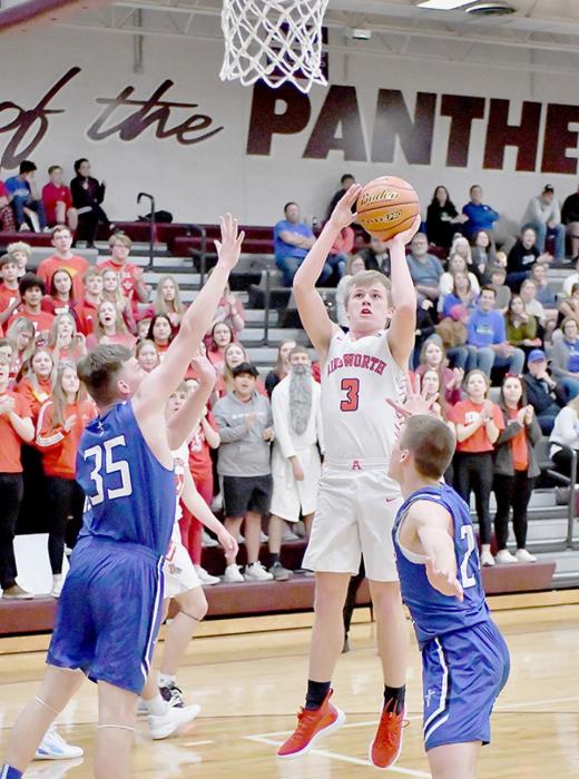 Senior Cash Reynolds goes up for a two-point jump shot over two Lourdes Central Catholic Knights in the District Final game on February 28th. Reynolds averaged 6.0 points per game this season for the Ainsworth Bulldogs.