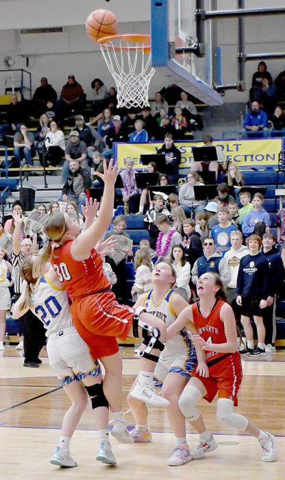 Vying for rebound position, Ainsworth and West Holt players watch the ball teeter on the rim. The Ainsworth shot finally dropped in to two-points.
