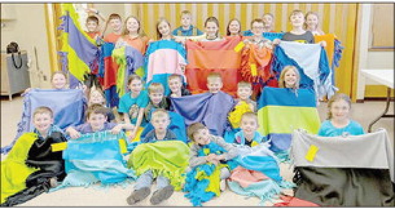 Kids Zone children finished their 2022-23 school year and display the fleece blankets they made to donate to Bright Horizons.