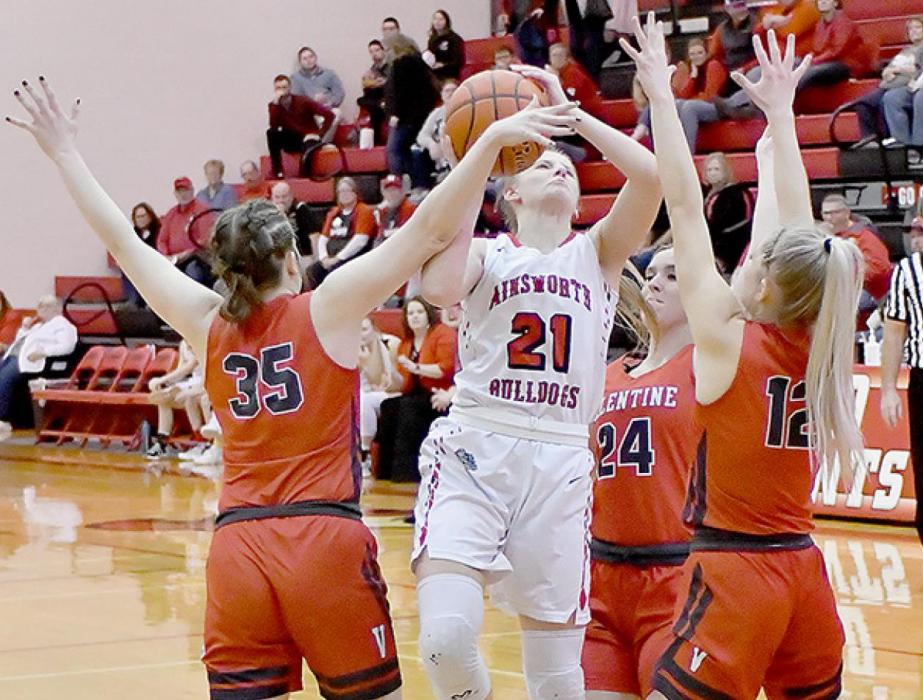 Madelyn Goochey drives through three Valentine defenders for two points in Ainsworth’s win over Valentine.