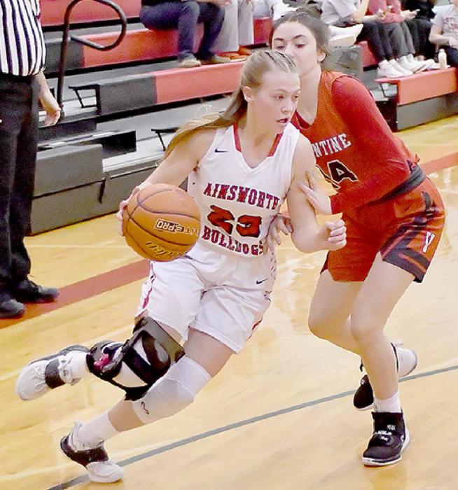 Kendyl Delimont drives around Alivia Patterson of Valentine in the C1-11 Sub District game in Ord. K. Delimont scored seven points against Valentine.