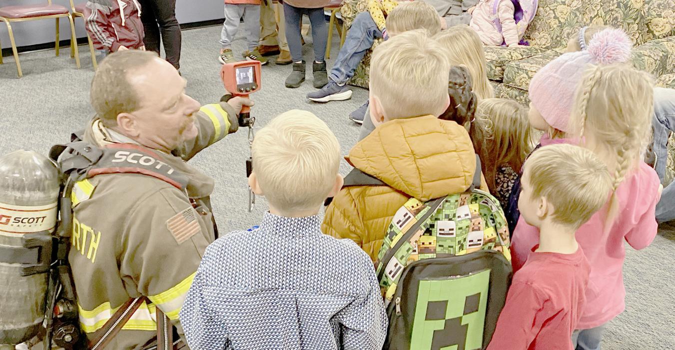 Ainsworth Volunteer Firemen delayed activities with youth from the area during Fire Prevention Week due to bad weather. Even though activities were delayed a week, bad weather required activities to be held inside. Fireman Kurt Starkey is shown above at Kayla Arens Day Care using a piece of equipment to show students’ fingerprints on a wall they had just touched.