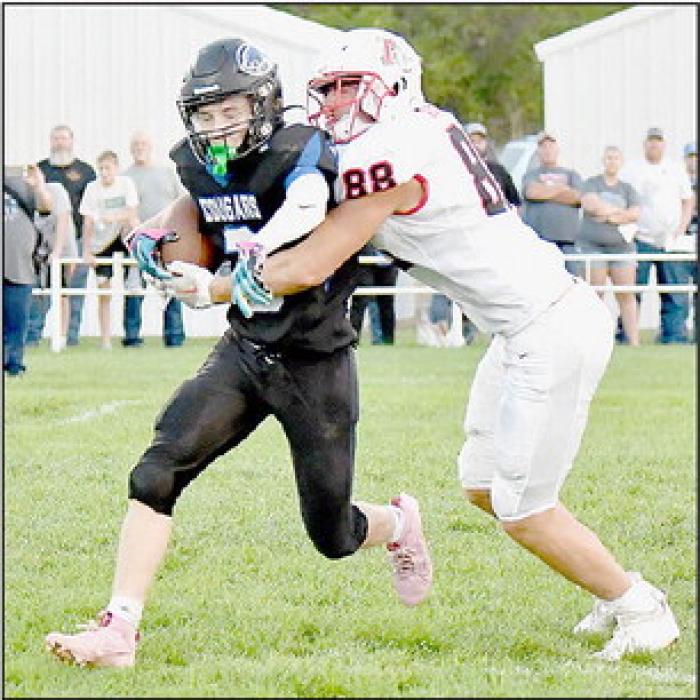 Ainsworth’s Trey Appelt catches Wade Pritchett in the Cougar’s backfield. Appelt had seven tackles and a fumble recovery against Niobrara-Verdigre.