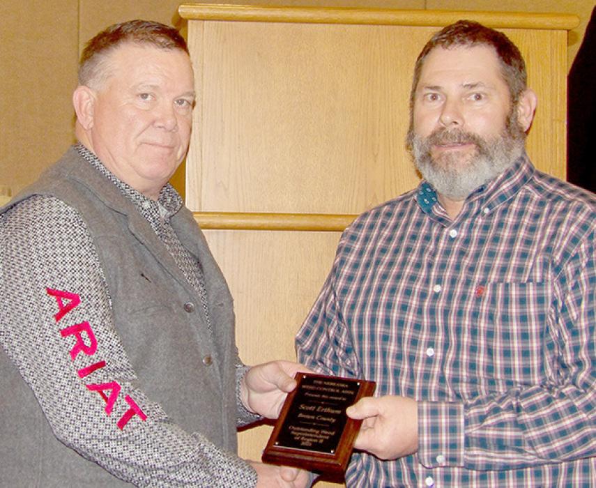 Nebraska Weed Control Association President John Bebout (left) presents the NWCA award for Region 2 to Brown County Weed Superintendent Scott Erthum (right).