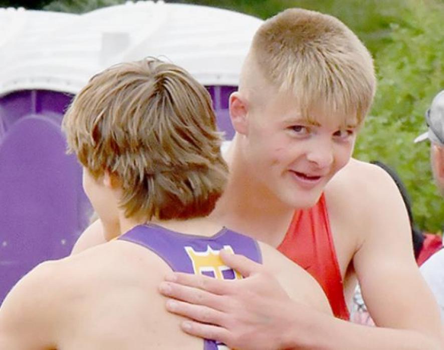 Carter Nelson (right) and Landon Olson of Battle Creek (left) congratulate each other after the record setting High Jump competition.