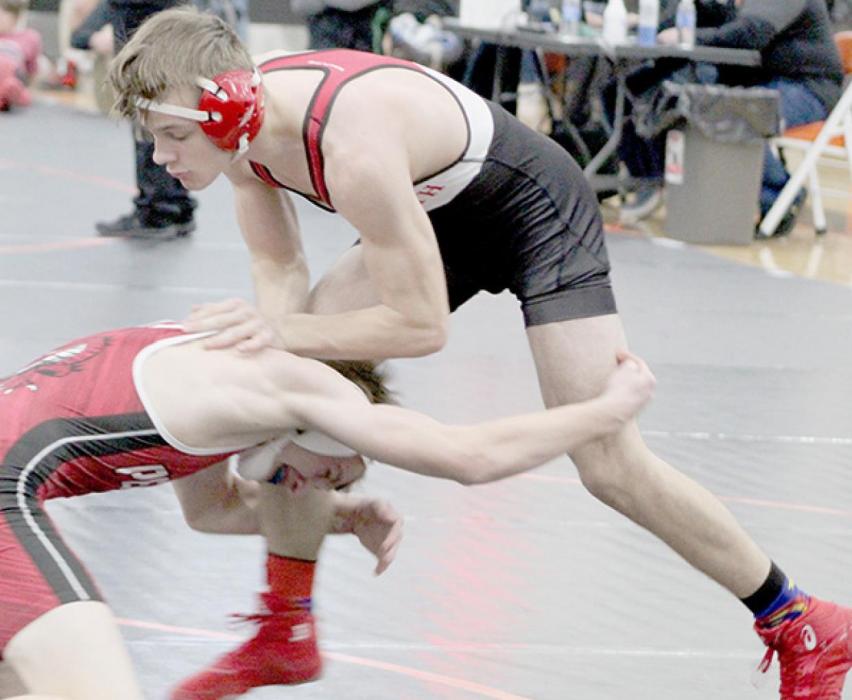 Owen Blumenstock avoids a take down by Braxton Volk of Pender in the 145 lb. weight class. Photos by Rachel Williams