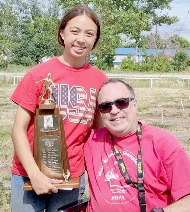 Randy Roggasch (right) presented the Dennis Roggasch Memorial traveling trophy to Lilly Strong (left).