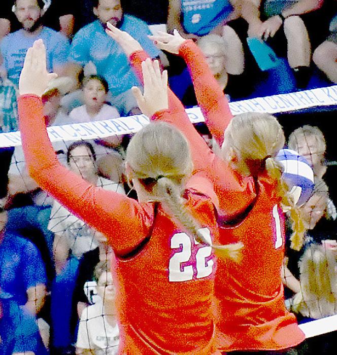 Gracyn Painter (22) and Kendyl Delimont (1) go up for a double block and score a point for the Bulldogs.