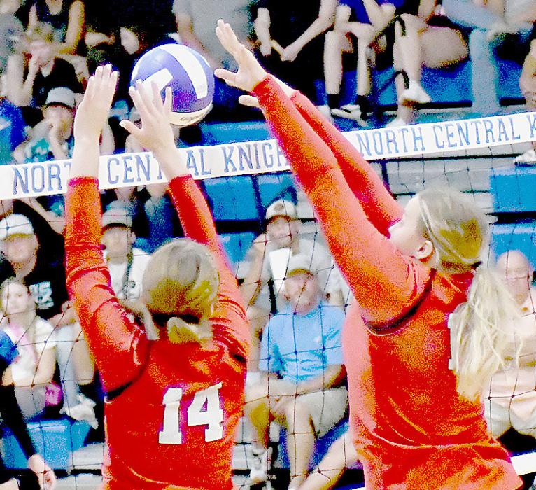 Cheyan Temple and Jocelyn Good go for the block to score a point for the Bulldogs.