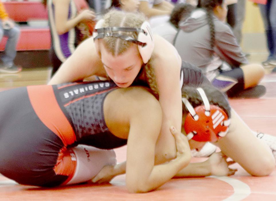 Jolyn Pozehl, 115 lb. weight class, gets ready to roll over Leynn Luna of Boone Central for a pin in the Semifinal round. Pozehl took first place in the 115 lb. weight class.