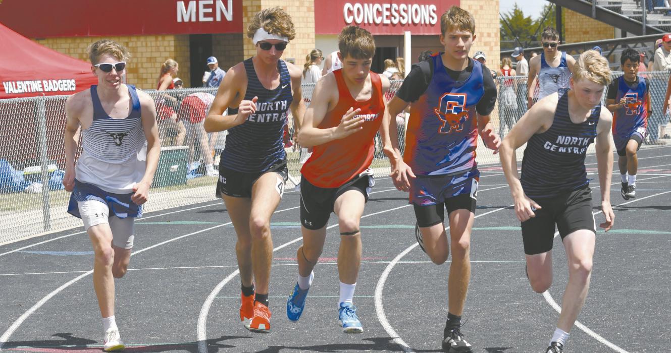Junior Holden Beel (center) takes off at the start of the 1600 meter run. Beel placed second in the event, finishing the mile with a time of 4:57.