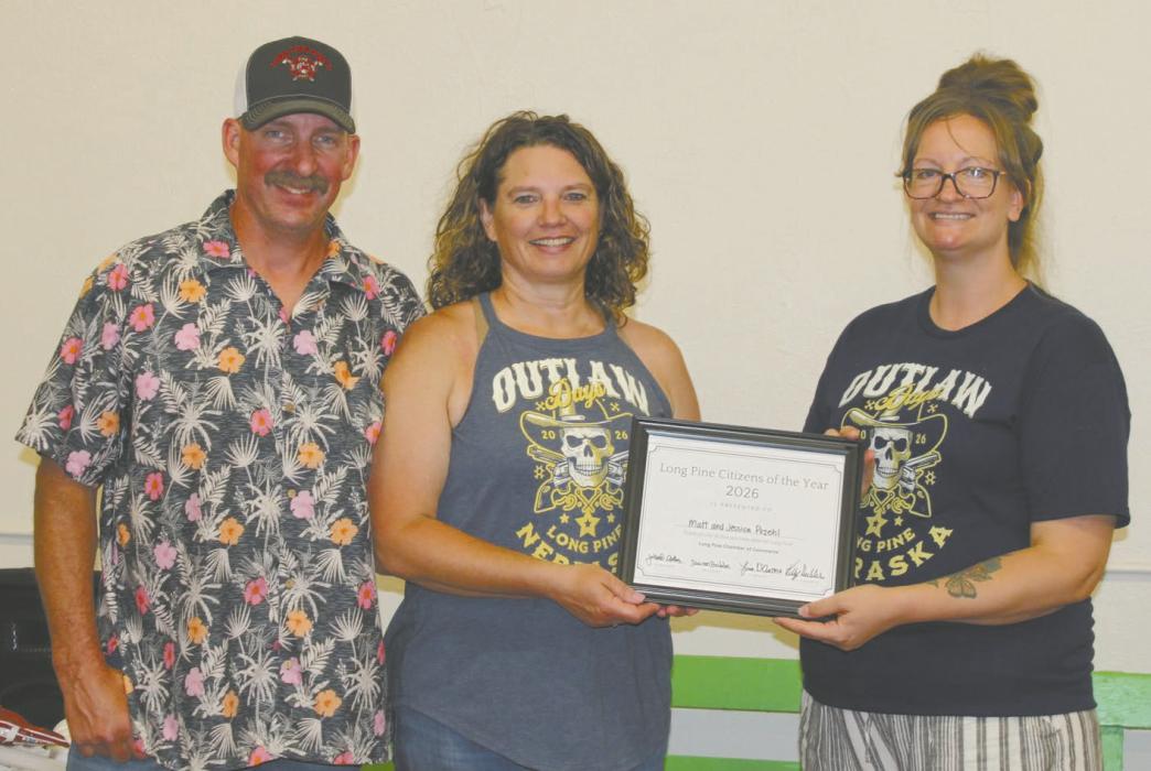 Matt and Jessica Pozehl also won the Long Pine citizens of the year award. Jessie Dillon, president of the Long Pine Chamber of Commerce, presented the couple with the award. Photo Courtesy of Lindy Sanford