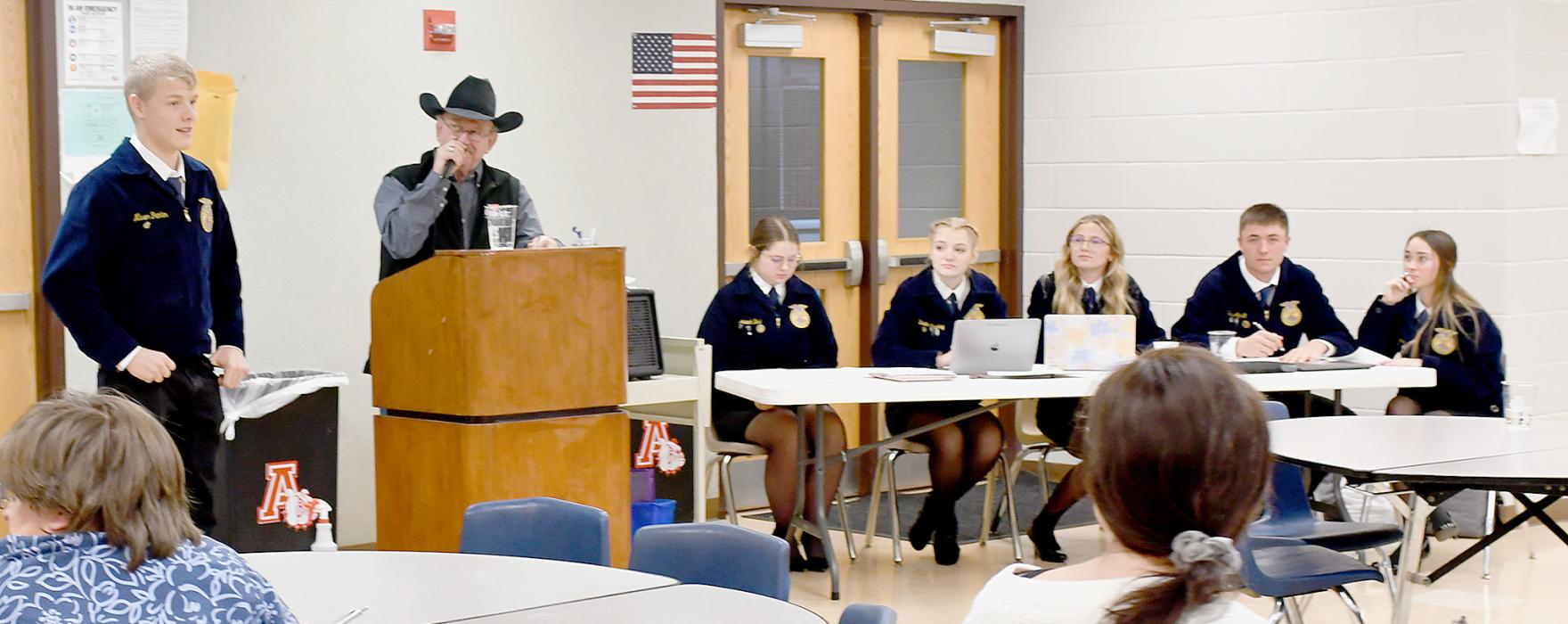 Junior Mason Painter was one of the Ainsworth FFA members sold during the Annual FFA Labor Auction. Each FFA member will spend 8 hours doing what ever chores needed to be done by their buyer, in this case, Mason will be working for the O’Hare Ranch. Mike Baxter served as the auctioneer for the event. Officers assisting with taking down bids and bidder names were sitting (left to right): Hannah Beel, Brianna Starkey, Emma Kennedy, Trey Appelt and Tessa Barthel.