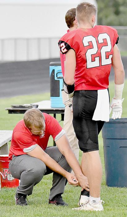 Robbie France of the Brown County Hospital Physical Therapy Department works on Carter Nelson’s ankle. Someone from the Physical Therapy Department attends every football game to offer their expertise.