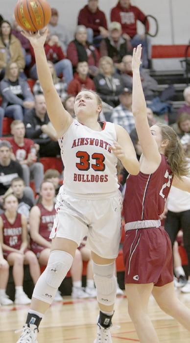 #33 senior Kaitlyn Nelson goes up for two points against the Gothenburg Swedes. Nelson currently leads the Dawgs in rebounds per game, averaging 8.1. Photo by Debb Gracey