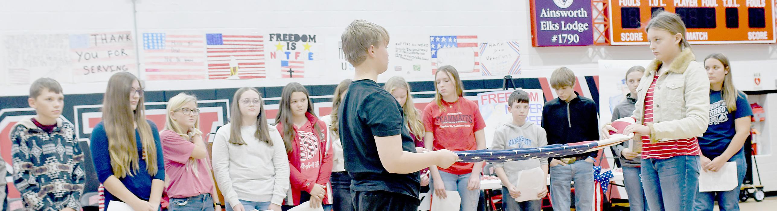 The seventh grade students read what each fold of the flag represented as Kristofer Hitchcock and Ava Graff made each fold to the flag. More photos of the Veterans Day Program and be found in this issue on page 8.