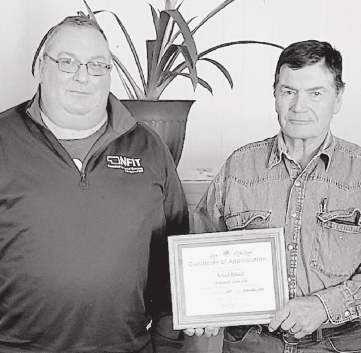 Lions Club President Bob Beatty (left) awarded Lion Roland Paddock (right) the Lion of the Year.