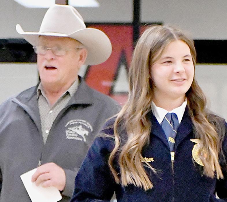 Ringman Dave Fowler helps with auctioneering senior Miah Ortner during the Ainsworth FFA Hired Hand Auction. Ortner will spend her eight hours working for Beddows Clydesdales.