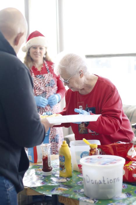Bonnie Finley serves food during the Holiday Festival held in the showroom of 1st Class Auto in Ainsworth. The festival spanned several days and offered shoppers a place to warm up, purchase holiday decor, grab some food, and proceeds went to projects across Ainsworth.