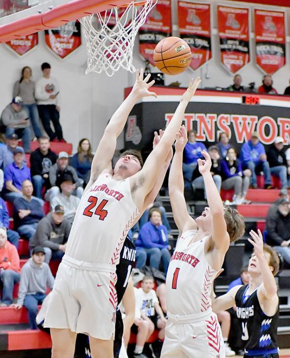 Trey Appelt and Morgan Kinney go up after a rebound during the Dawgs win over the North Central Knights.