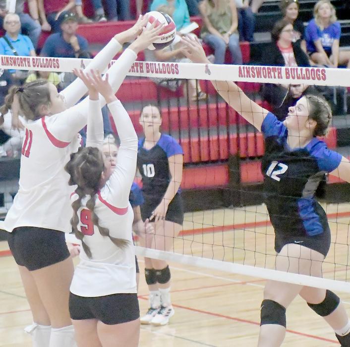 Bulldogs Karlie Kral (11) and Saylen Young (9) team up to block the net against Knight Allie Stephen (12) to earn a point for the team. The Bulldogs won in three sets, 25-22, 25-19 and 25-18. The Bulldogs opened their 2022 - 23 season with a clean sweep over the Knights with the Reserves, Junior Varsity and Varsity all winning.