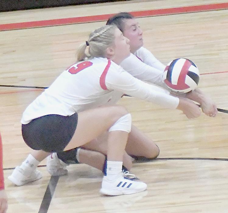 Teammates, seniors Ally Conroy and Dakota Stutzman, receive the serve.