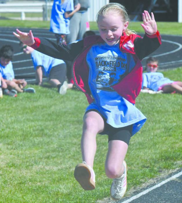 Ainsworth second-grader Nicolette Ashcraft competes in the long jump during the school’s track day on May 8.