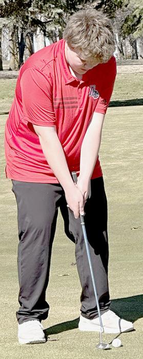 David Cook prepares to putt during the Ainsworth Triangular.