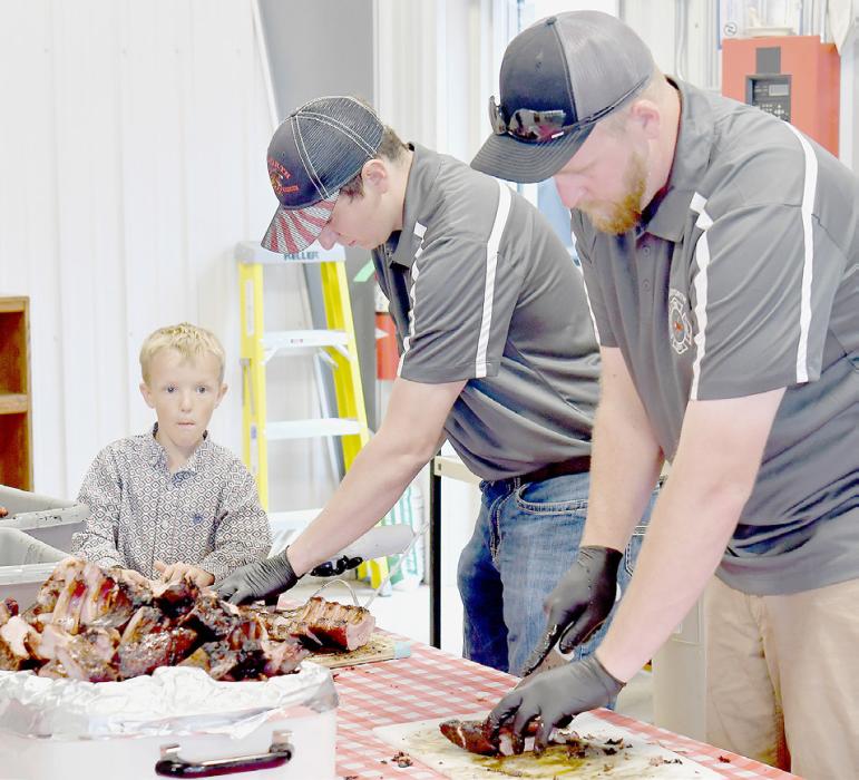 (Right) once the ribs were cut up, they were served. (Above) After attendees ate their ribs, they could enjoy dessert made by members of Bethany Chapter #113 Order of Eastern Star, brownies and homemade ice cream.