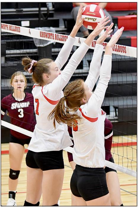 Cameryn Goochey (#7) pushes the ball back over the net with the assistance of Eden Raymond (#3) after a hit by the Stuart center.