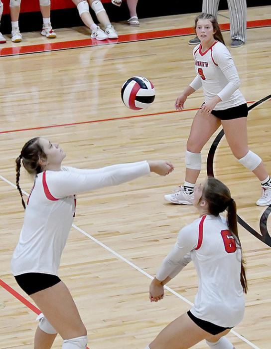 Karli Kral, Lauren Ortner and Saylen Young work together as a team in making sure this serve heads back over to the opponents side.