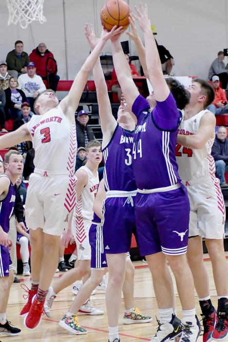 Cash Reynolds, #3, goes up for a rebound against two Burwell defenders. Reynolds had four points and five rebounds in the game.