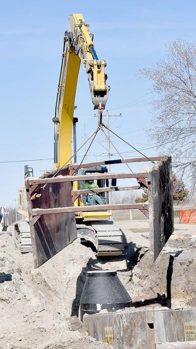 Myers Construction crews have been working since March to install a new sewer line and manholes on North Main Street from the Ainsworth Waste Water Treatment plant to Highway 20. They are lifting a cage that was used to protect workers from dirt cave ins while installing a new manhole.