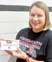 Roberta Denny, English teacher at Ainsworth Community Schools, proudly displayed her plaque she received from Yale Undergraduate Admissions for being recipient of one of their 2022 Yale Educator Awards.