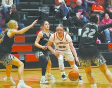 Gracyn Painter takes the ball to the hoop, bypassing three members of the Spartan defense.