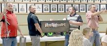 One of the hot items up for auction during the Bulldog Pride Fundraiser was this Bulldog Firepit that was donated by 1st Class Auto. The firepit was filled with plenty of extras to make for a fun evening around the bonfire. Helping Auctioneer Tony Ruhter (right) were Jeff Sisson, Jake Graff and Troy Brodbeck.