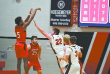 Ainsworth senior Witten Painter (22) attempts to block a shot taken by Winside’s Jahiem Hamik (5).