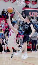 Jacob Held goes up for a lay up on a fast break, but the ball was deflected at the last second by Carson Cooksley of Sandhills/Thedford.