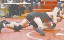Holden Beel works to pin an opponent in a match last season. He was one of two NSAA Boys State Wrestling Qualifiers last season.
