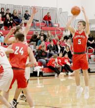 Treagan McNally shoots a three-point shot against Valentine. McNalley scored 13 points against the Valentine Badgers and scored 32 points against the McCook Bison.