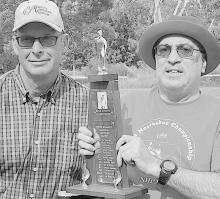 Randy Roggasch (right) presented the Dennis Roggasch Memorial traveling trophy to Jim Sybrant (left).