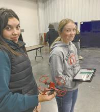 Braylin Rudnick (left) and Kenley Welke (right) learn about precision ag through drone demonstrations with Northeast Community College. Photo Courtesy of Josie Ganser, Ainsworth FFA Advisor