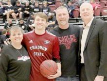 Gage Delimont is shown with his parents, Brian and Laurie, along with CSC’s Head Coach Shane Paben. Delimont has concluded his career at Chadron State. Photo by Con Marshall, Chadron State College