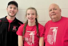 AHS freshman Jolyn Pozehl (center) pinned her way to first place at girls wrestling districts on February 4th and 5th. She will be the first girl wrestler to represent the Bulldogs at the State Wrestling Tournament in Omaha on February 17th - 19th. She is pictured with assistant coach Oren Pozehl (left) and head coach Todd Pollock (right).