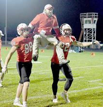 Following their 8th win of the season, Trey Appelt (left) and Carter Nelson (right) put Head Coach Jessi Owen on their shoulders and carried him to the west end zone where the entire football team was waiting.