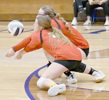 Gracyn Painter and Cheyan Temple go after the same serve during Ainsworth’s Sub-District game against West Holt.