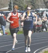 Sam Titus (left) works to pass the North Central 3200 meter relay team.