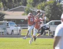 Jacob Ortner (15) and Bateson Raymond (11) attempt to intercept a pass meant for North Central's Brandt LeZotte (2).